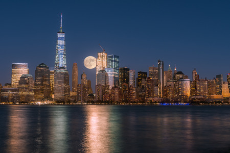 Perigee full moon over the skyscrapers of lower Manhattan-New Yorkの写真素材