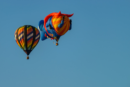 Colorful hot air balloons against blue skyの写真素材