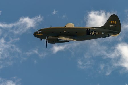 READING, PA - JUNE 3, 2017: CURTISS
C-46 "COMMANDO"'TINKER BELLE'in flight during World War II reenactment at Mid-Atlantic Air Museumのeditorial素材