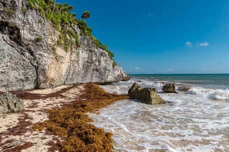 Beautiful beach in Tulum Mexico, Mayan ruins on top of the cliff.の写真素材