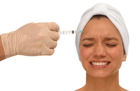 Woman receiving painful injection to reduce wrinklesの写真素材