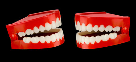 A pair of toy chattering teeth isolated on a black background 