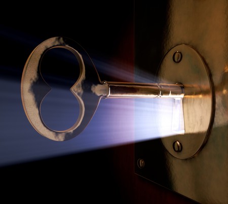 A close-up of a key inside the key hole.の写真素材