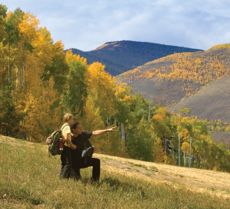 Father and son on a hike in the Rocky Mountains during autumnの写真素材