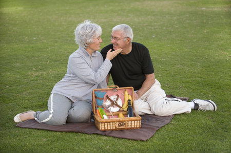 Senior couple enjoying a romantic picnicの写真素材
