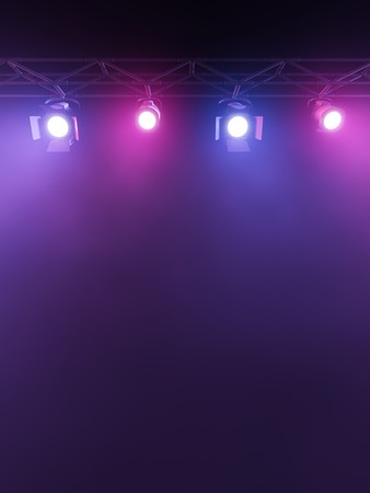 A Stage Light Rack with 3  Colored Spotlights Shining down towards the middle of the layout in a dark area.の写真素材