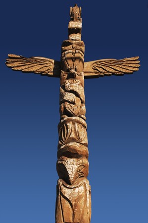 American Indian totem pole against blue skyの写真素材