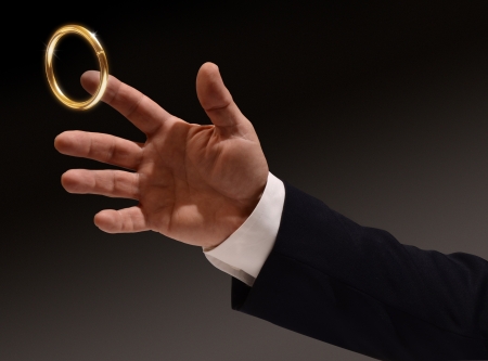 Business man's hand reaching for the brass ringの写真素材