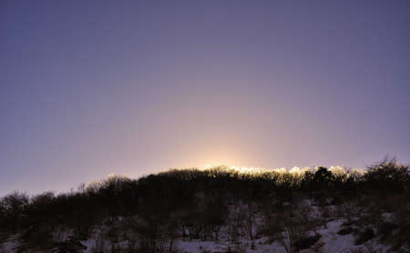 light on the winter mountainの写真素材