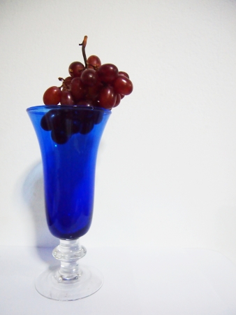 Purple grape and a glass of wineの写真素材