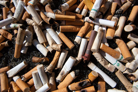 Cigarette butts fill an ash tray.
