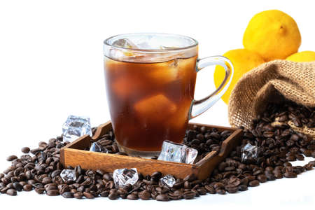 Iced black coffee in glass and lemon with coffee beans, isolated on white background.の写真素材
