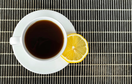 Black coffee with lemon slices, on an old dust filter, romantic in morning.の写真素材