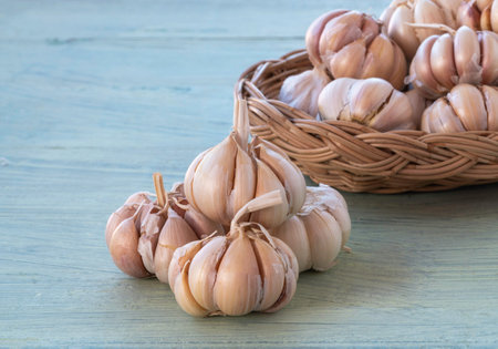 Garlic Bulbs on green wooden background