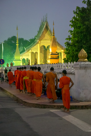 Luang Prabang. February 6, 2016. Monks collecting the morning alms in Luang Prabang. The city is a UNESCO world heritage site in Laosのeditorial素材