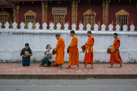 Luang Prabang. February 6, 2016. Monks collecting the morning alms in Luang Prabang. The city is a UNESCO world heritage site in Laosのeditorial素材