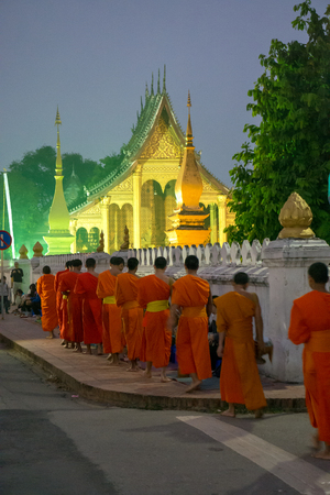 Luang Prabang. February 6, 2016. Monks collecting the morning alms in Luang Prabang. The city is a UNESCO world heritage site in Laosのeditorial素材