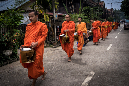 Luang Prabang. February 6, 2016. Monks collecting the morning alms in Luang Prabang. The city is a UNESCO world heritage site in Laosのeditorial素材