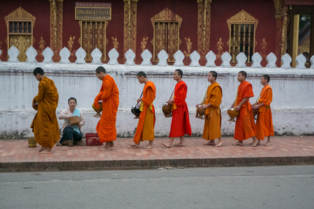 Luang Prabang. February 6, 2016. Monks collecting the morning alms in Luang Prabang. The city is a UNESCO world heritage site in Laosのeditorial素材