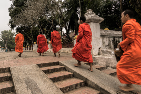 Luang Prabang. February 6, 2016. Monks collecting the morning alms in Luang Prabang. The city is a UNESCO world heritage site in Laosのeditorial素材