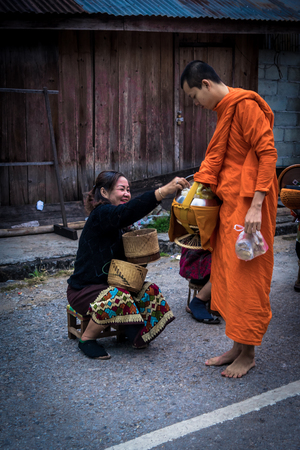 Luang Prabang. February 6, 2016. Monks collecting the morning alms in Luang Prabang. The city is a UNESCO world heritage site in Laosのeditorial素材
