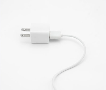 White plug with two flat pins electrical equipment on white background.