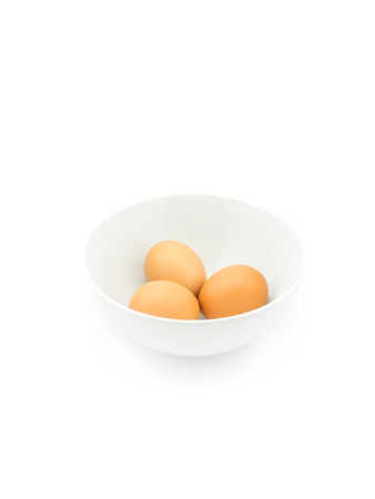 Eggs in white bowl isolated on white backgroundの写真素材