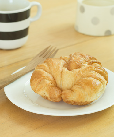 Breakfast , Croissant on white plate and cup of coffee.の写真素材