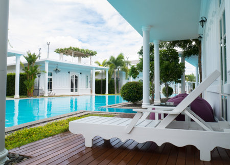 HUA HIN, THAILAND- AUGUST 08,2015: Relaxing pool chair beside of swimming pool in hotel. Hua hin is wonderful beaches and the most popular for tourists and the best  place where to spend a romantic weekend or a family trip.のeditorial素材