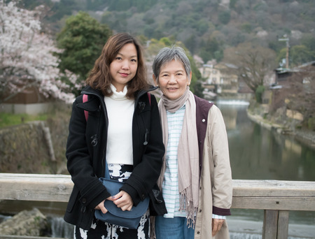 Asian women portrait - Senior mother and adult daughter looking and smiling to the camera at Nishikyo-ku, Kyoto, Japanの写真素材