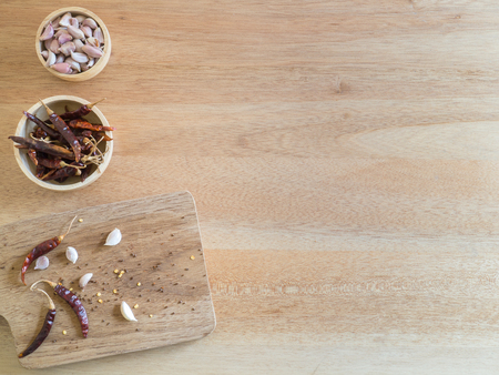 Top view - Dried red chili peppers and garlic on wooden board ( Space and composition for text )の写真素材