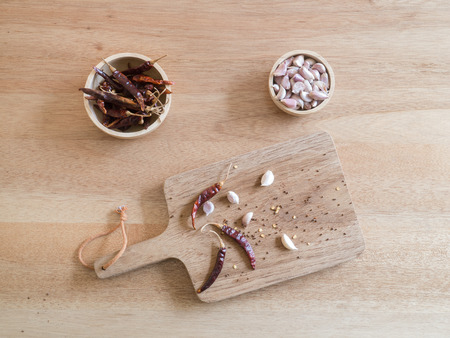 Top view - Dried red chili peppers and garlic on wooden boardの写真素材