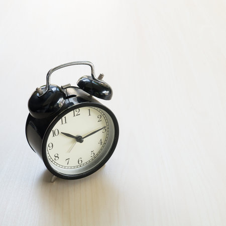 Vintage Retro black alarm clock on wooden background ( Composition and space foe text )の写真素材