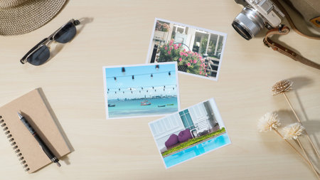 Top view of Travel and vacation photo frames and items, camera, sunglasses, notebook on wooden table...