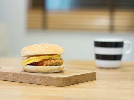 Homemade hamburger with fried egg on chopping boardの写真素材