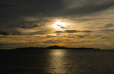 Landscape of silhouette island and the sea in sunset at Pattaya,Thailandの写真素材