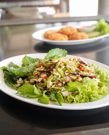 spicy herb salad in white plate ( Thai food style )の写真素材