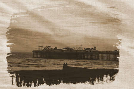 couple sitting by the sea in sepiaの写真素材