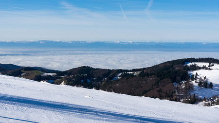over snowy mountain range and forest. landscape. Dramatic overcast sky with clouds. Black Forest, Germanyの写真素材