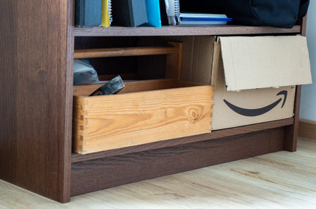 reuse of old packages cardboard as a box in a shelf. Upcycling.