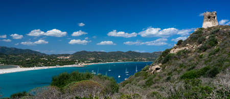 Panoramic view of a beautiful bay with yachts, blue water and old towerの写真素材