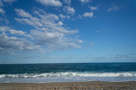 summer day at a beach. view of the sea with waves at a sunny dayの写真素材