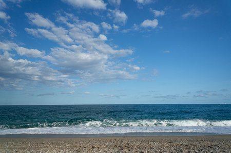 summer day at a beach. view of the sea with waves at a sunny dayの写真素材