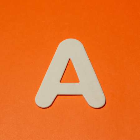 Uppercase letter A - wood texture - Orange backgroundの写真素材