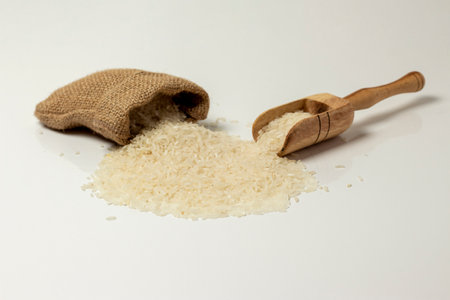 white background - spilled rice grainsの写真素材