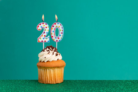 CupCake on bright green and flat green - Birthday candles with colorful dotsの写真素材