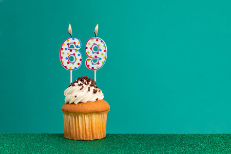 CupCake on bright green and flat green - Birthday candles with colorful dotsの写真素材