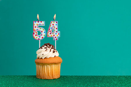CupCake on bright green and flat green - Birthday candles with colorful dotsの写真素材