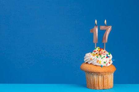 Birthday cupcake on blue background - pink birthday candle numberの写真素材