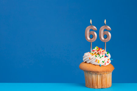 Birthday cupcake on blue background - pink birthday candle numberの写真素材